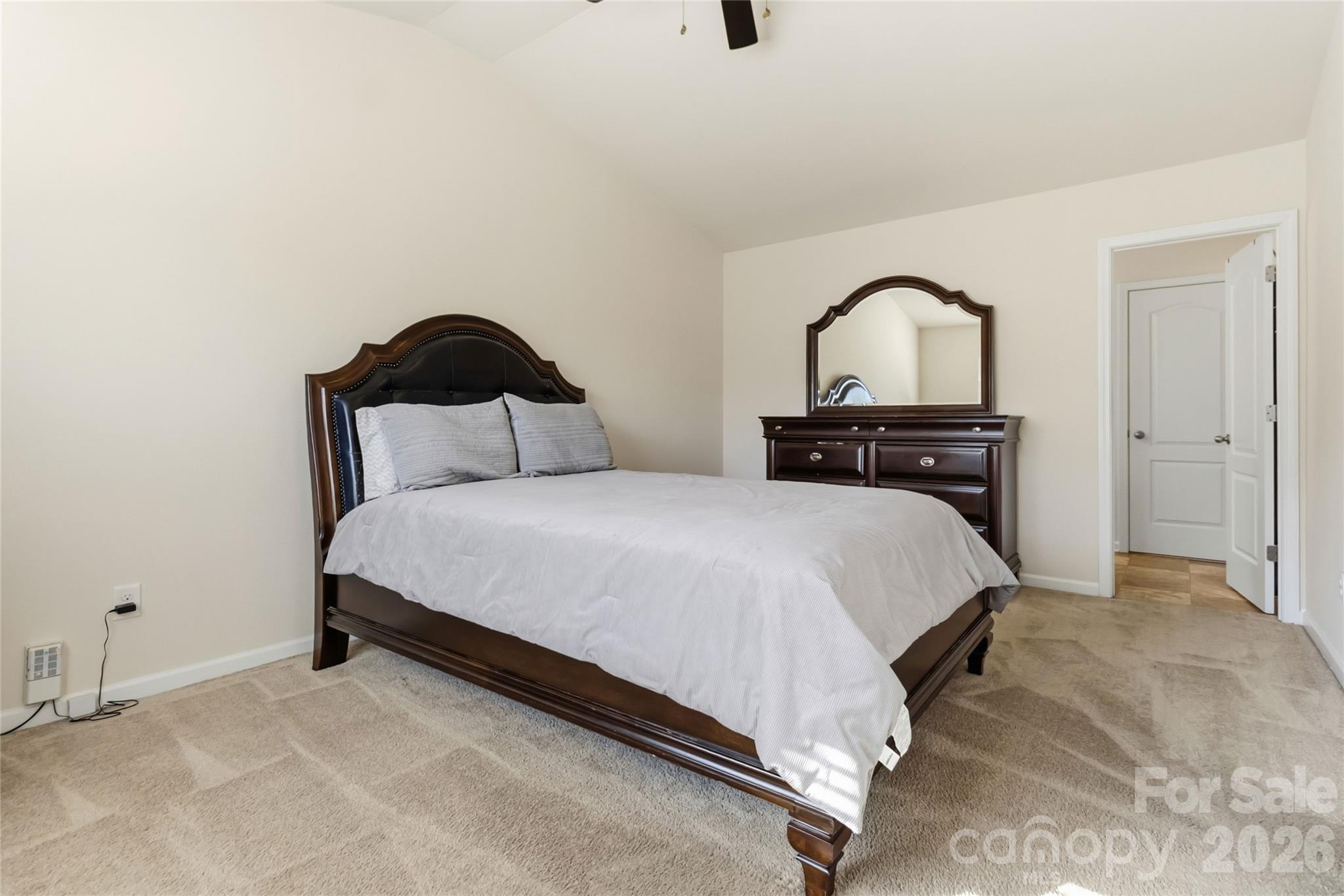 14015 Rory Glen Lane Charlotte, NC 28215 - Photo 23 of 28 a bedroom with a bed and a black countertop