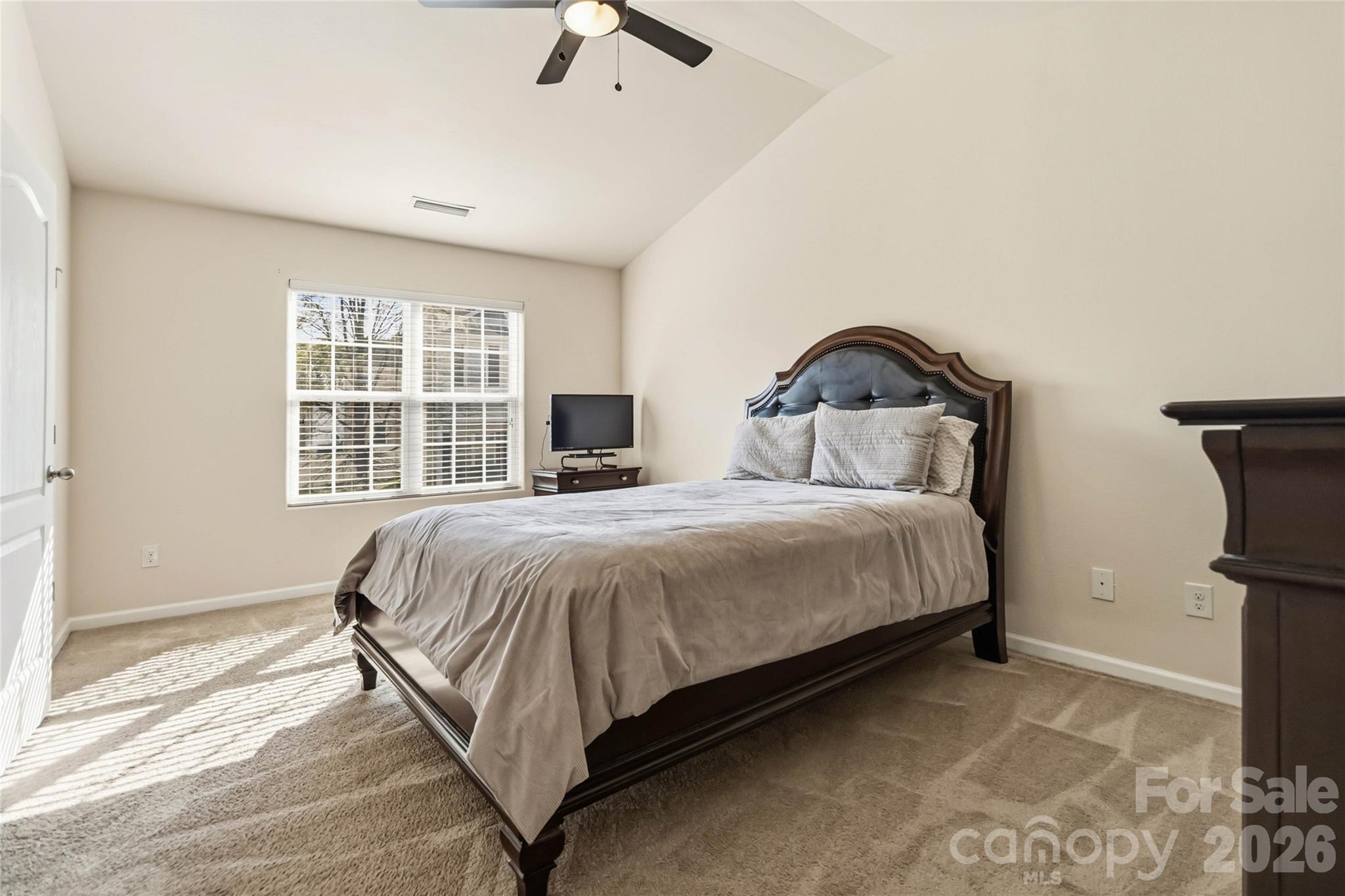 14015 Rory Glen Lane Charlotte, NC 28215 - Photo 24 of 28 a bedroom with a bed and a window