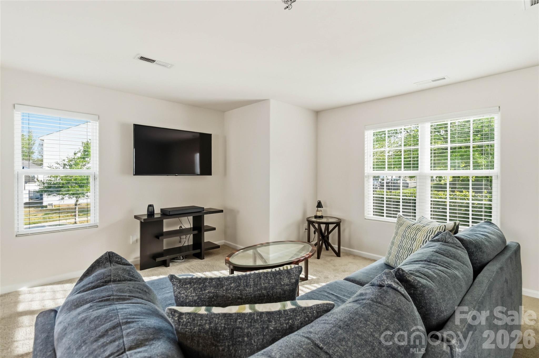 14015 Rory Glen Lane Charlotte, NC 28215 - Photo 7 of 28 a living room with furniture and a flat screen tv