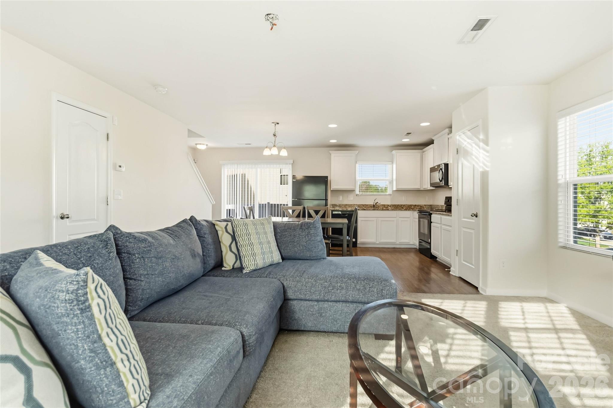 14015 Rory Glen Lane Charlotte, NC 28215 - Photo 9 of 28 a living room with a couch and a view of kitchen