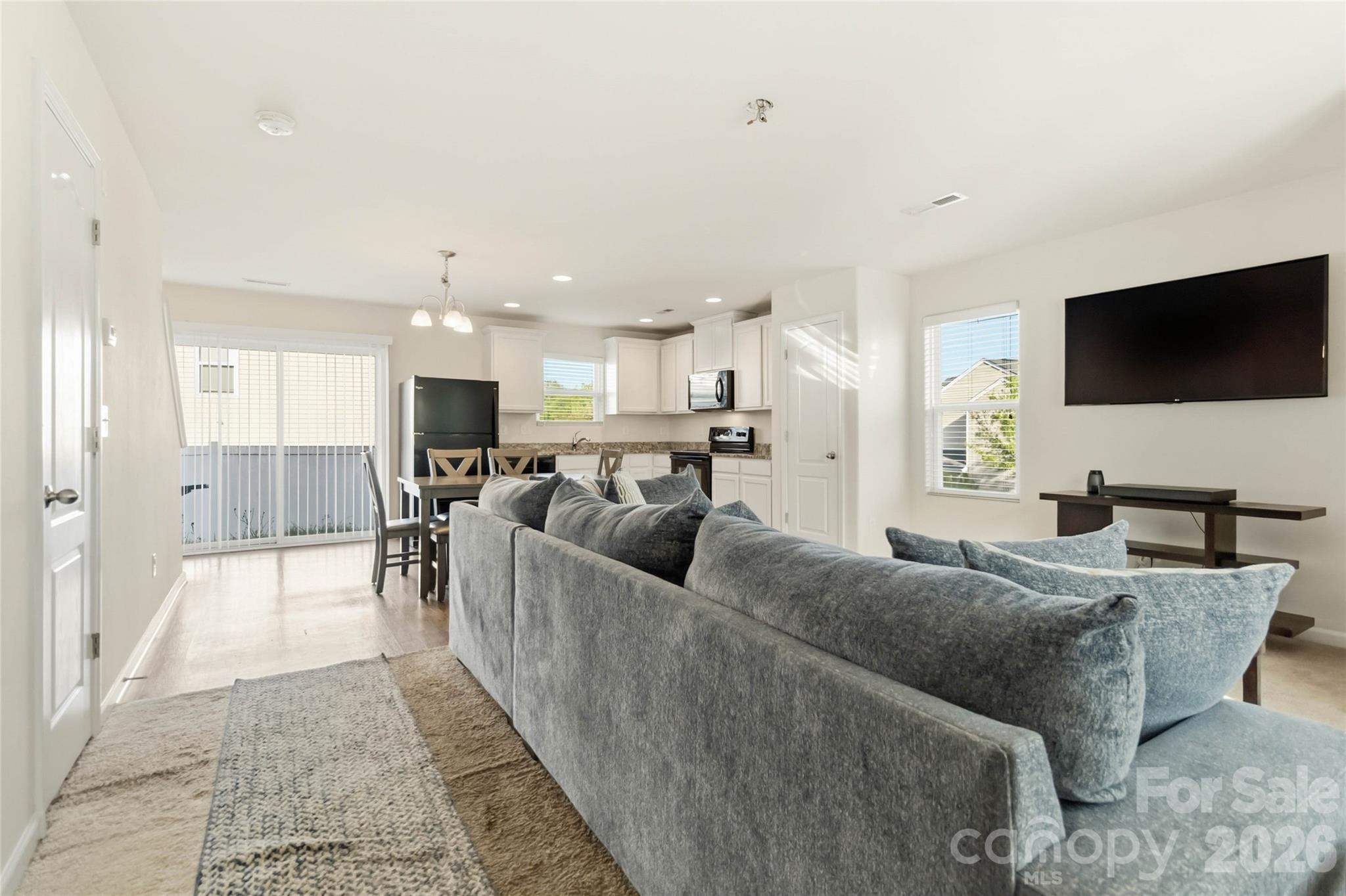 14015 Rory Glen Lane Charlotte, NC 28215 - Photo 10 of 28 a living room with furniture and a flat screen tv