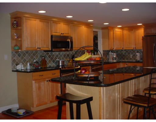 144 Tudor Road Needham, MA 02492 - Photo 2 of 5 a view of a living room and kitchen