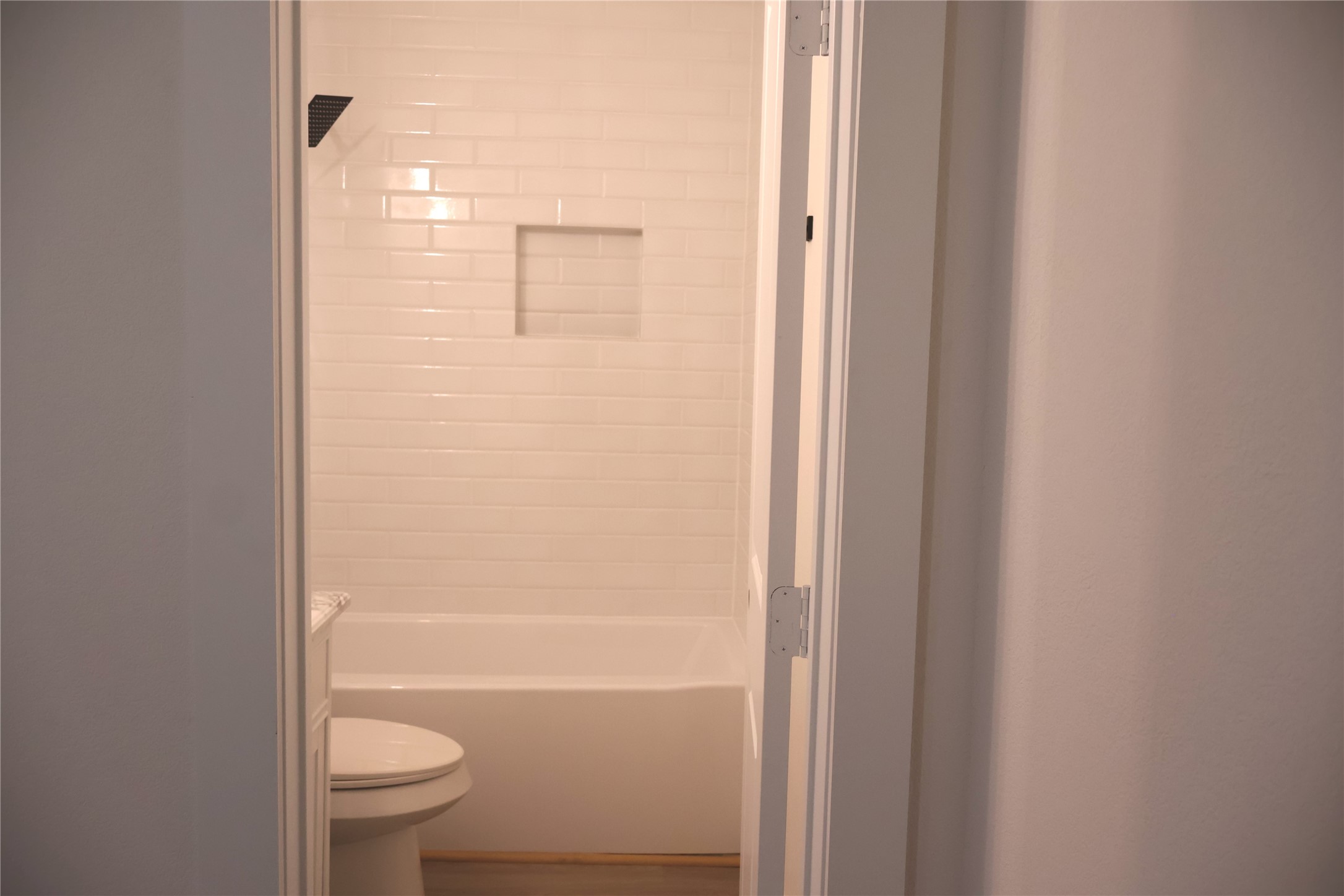 5602 Circlegate Drive, Unit B Spring, TX 77373 - Photo 6 of 8 a bathroom with a granite countertop toilet a sink and bathtub