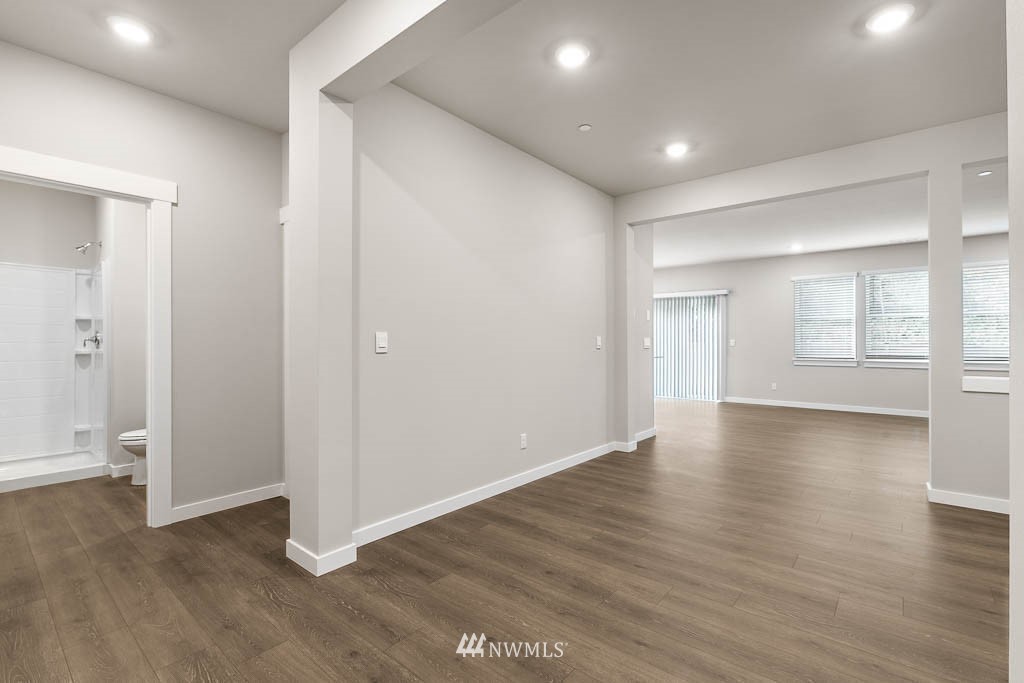 104 211th Street Southeast, Unit P18 Bothell, WA 98021 - Photo 13 of 31 an empty room with wooden floor and windows