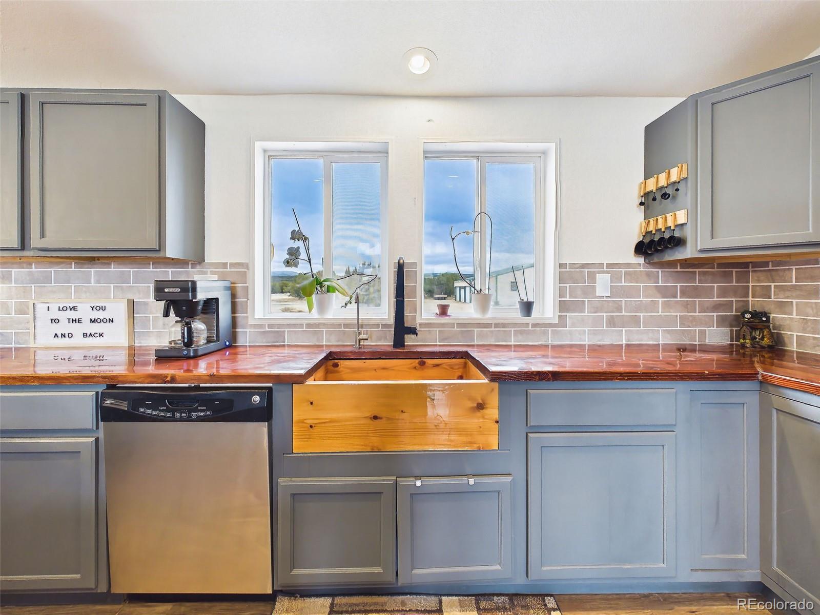 699 Cedar Hills Road Penrose, CO 81240 - Photo 12 of 50 a kitchen with stainless steel appliances granite countertop a sink and cabinets