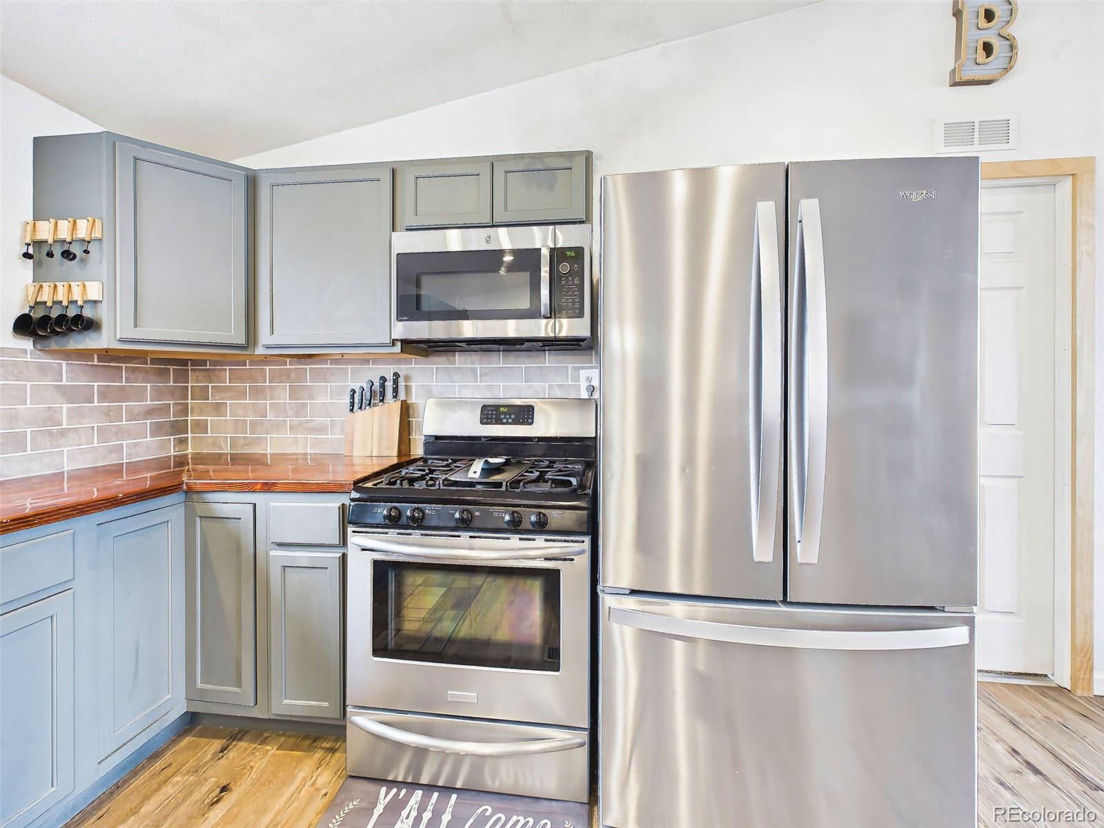 699 Cedar Hills Road Penrose, CO 81240 - Photo 15 of 50 a kitchen with stainless steel appliances granite countertop a refrigerator stove and sink