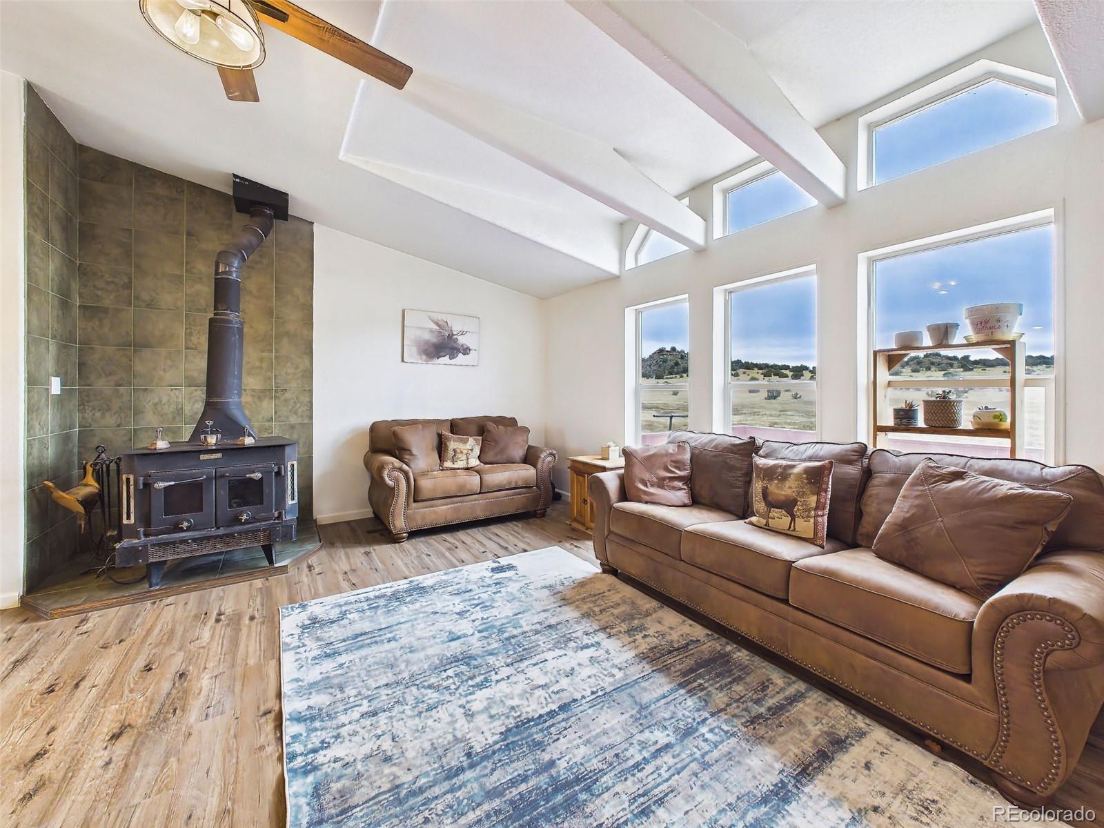 699 Cedar Hills Road Penrose, CO 81240 - Photo 19 of 50 a living room with furniture and a large window