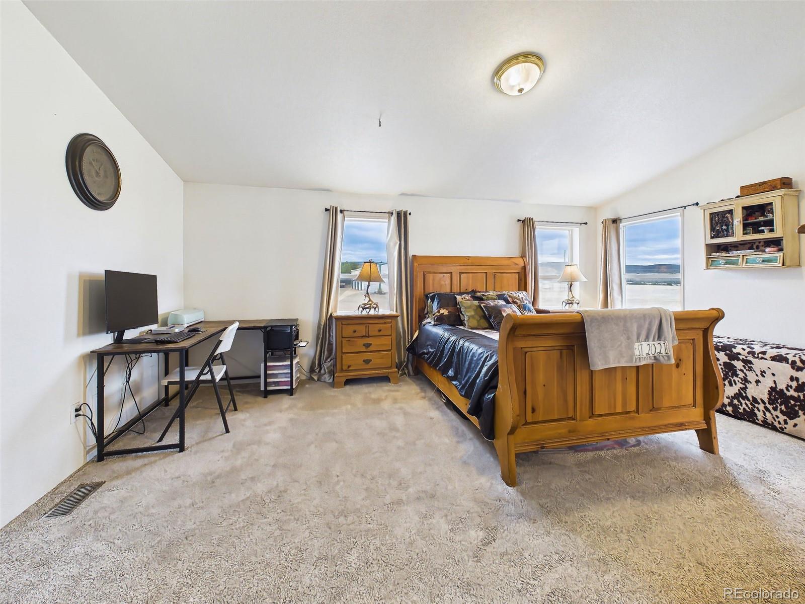 699 Cedar Hills Road Penrose, CO 81240 - Photo 21 of 50 a living room with furniture and a air conditioner vent