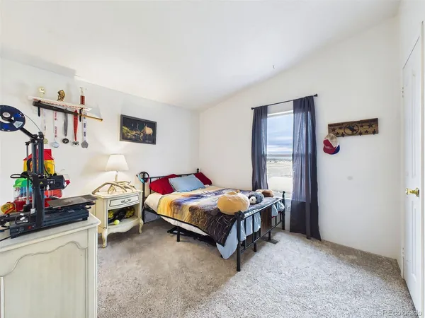 a bedroom with bed and a window