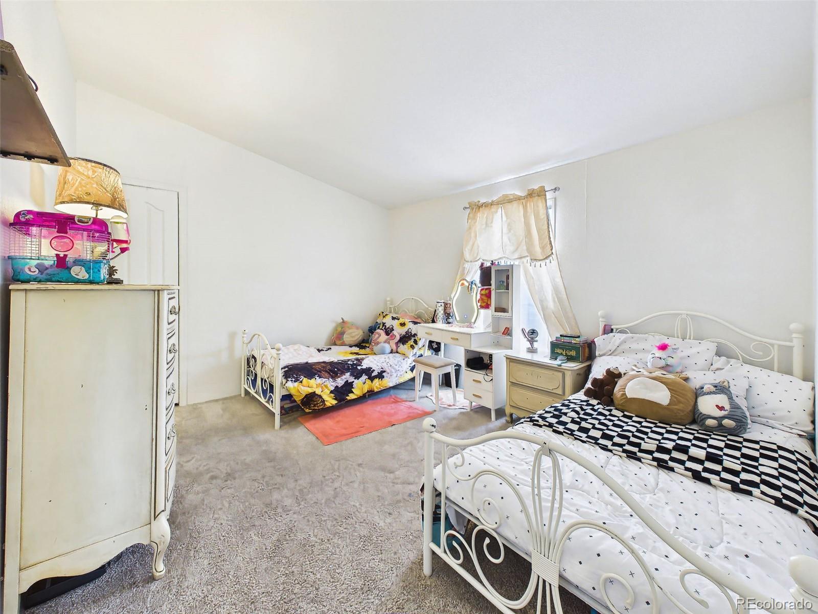 699 Cedar Hills Road Penrose, CO 81240 - Photo 29 of 50 a bedroom with bed and a window