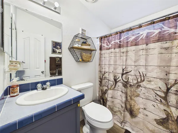 a kitchen with a refrigerator and a sink