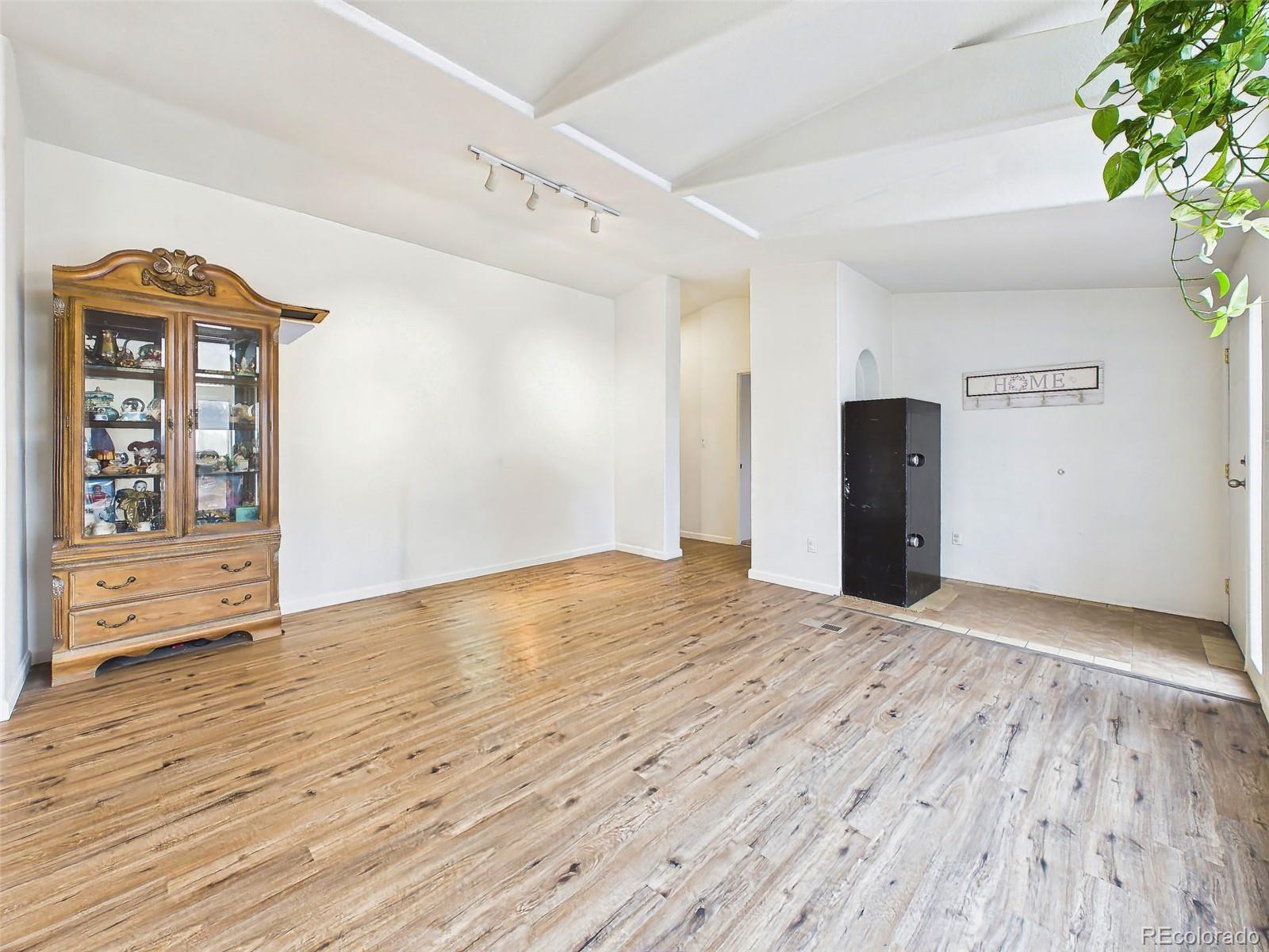 699 Cedar Hills Road Penrose, CO 81240 - Photo 4 of 50 a view of empty room with wooden floor and fan