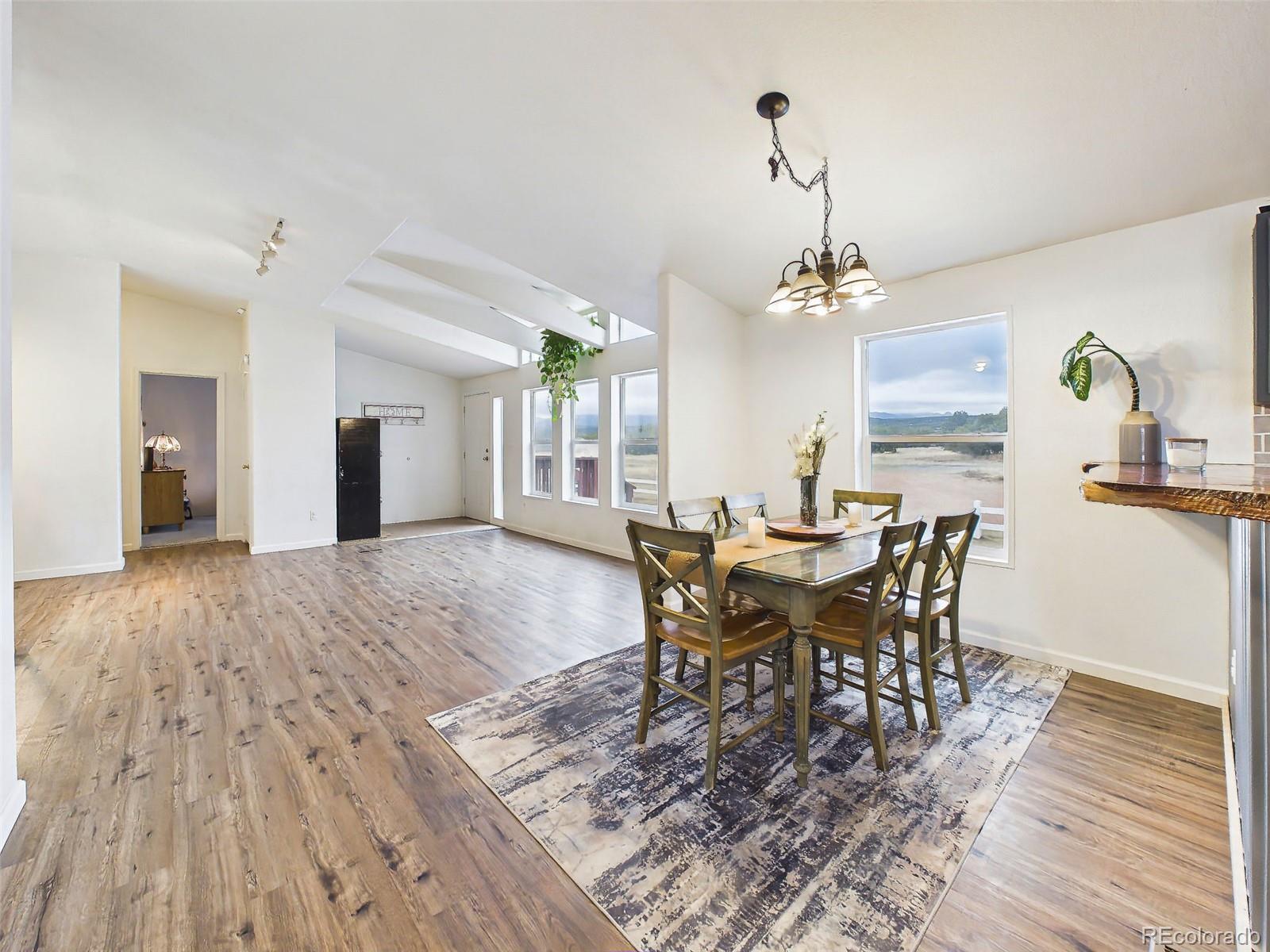 699 Cedar Hills Road Penrose, CO 81240 - Photo 7 of 50 a view of a dining room with furniture and wooden floor