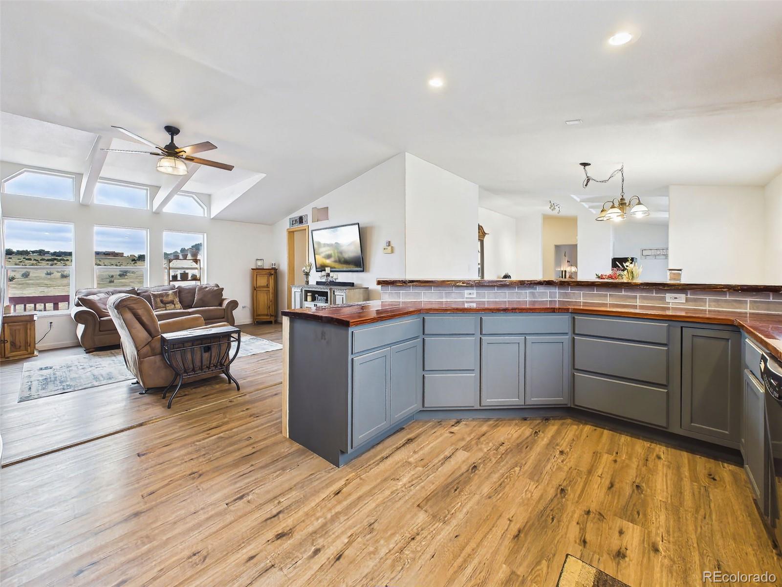 699 Cedar Hills Road Penrose, CO 81240 - Photo 10 of 50 a large kitchen with kitchen island a counter top space a sink stainless steel appliances and cabinets