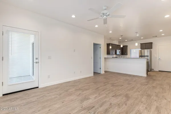 a view of a kitchen with a sink and a refrigerator