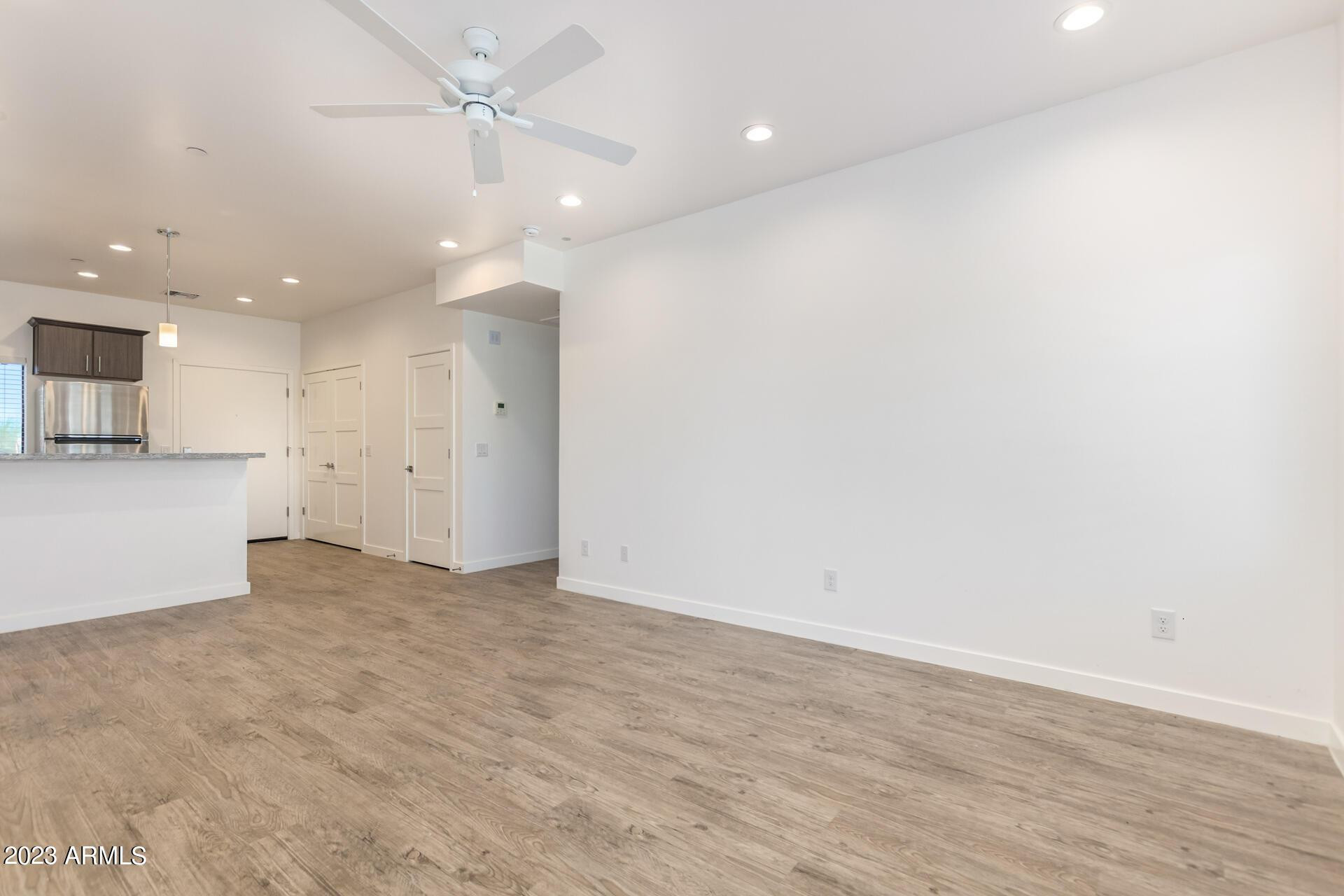 2063 East Lemon Street, Unit 2004 Tempe, AZ 85281 - Photo 8 of 25 wooden floor in an empty room with a kitchen
