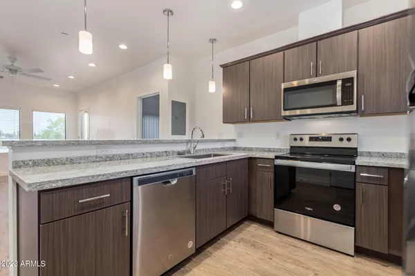 a kitchen with a sink stove and microwave