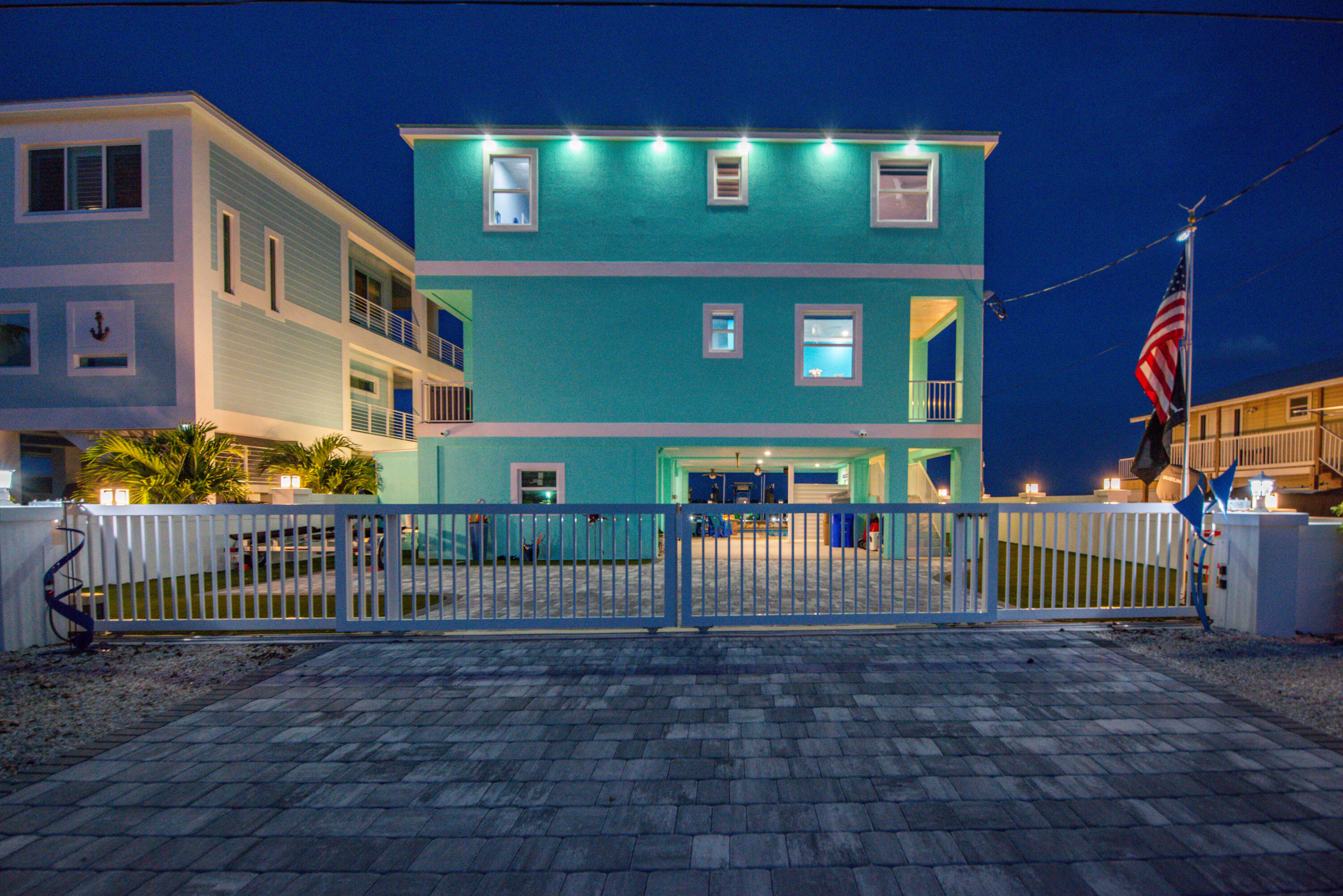 747 La Fitte Road Summerland Key, FL 33042 - Photo 29 of 103 a view of a brick house with large windows and a small yard