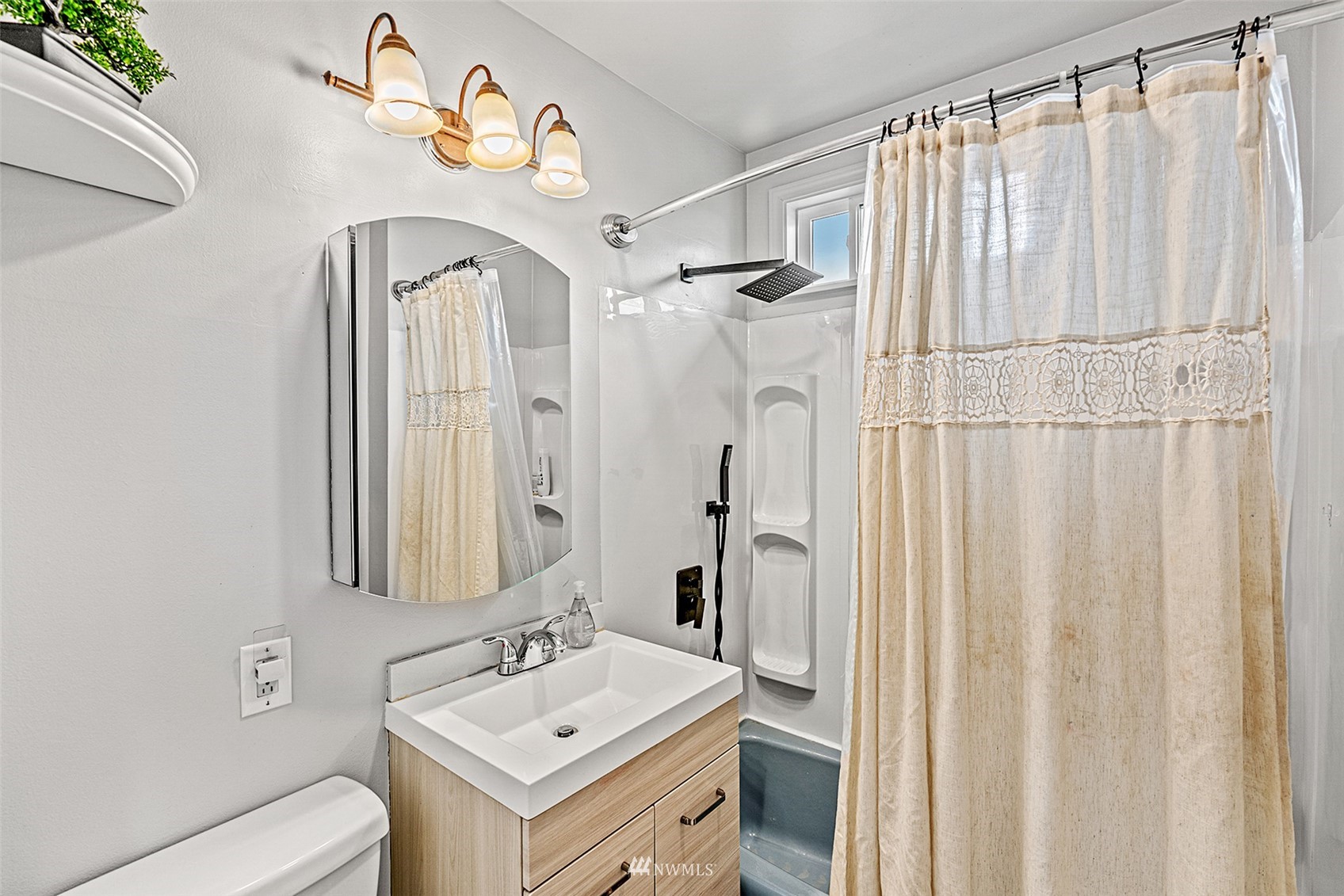 3626 Rockefeller Avenue Everett, WA 98201 - Photo 23 of 40 a bathroom with a sink vanity mirror and a toilet
