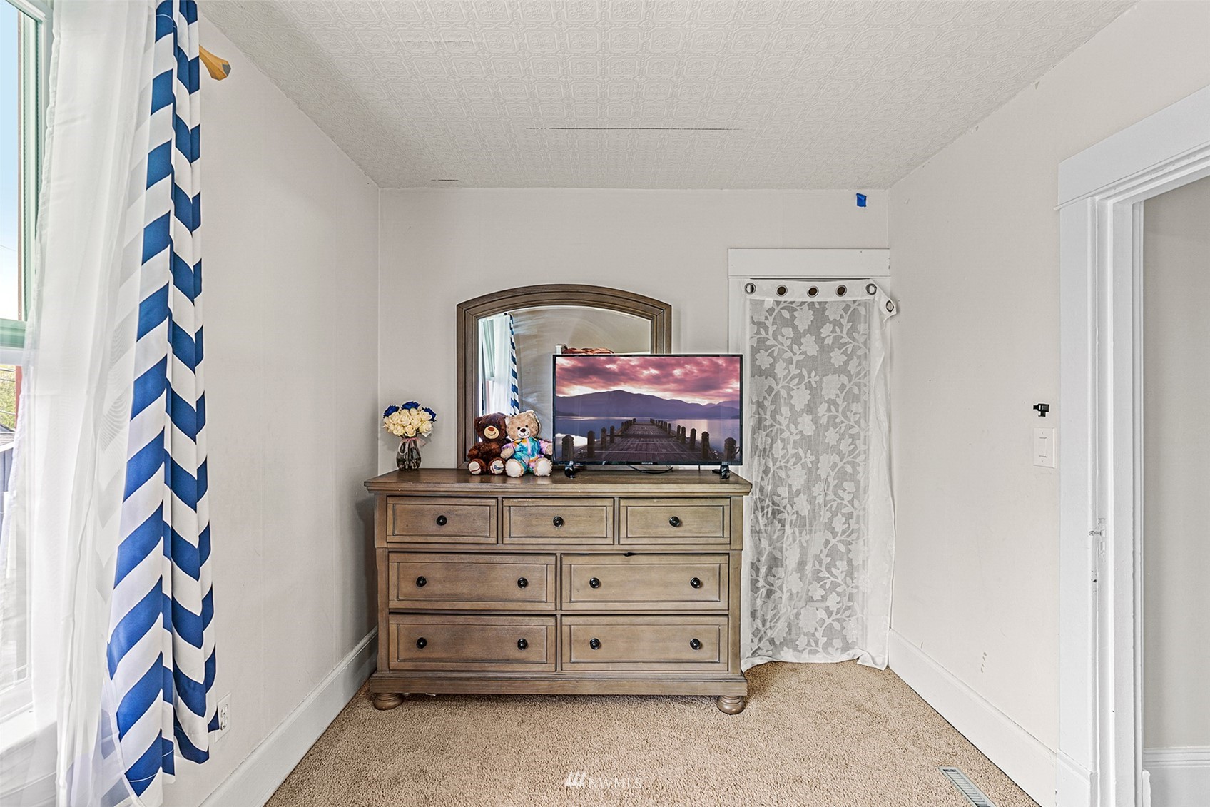 3626 Rockefeller Avenue Everett, WA 98201 - Photo 27 of 40 a view of a dresser with paintings on the wall