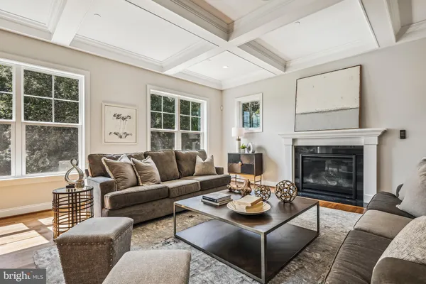 a living room with furniture and floor to ceiling windows