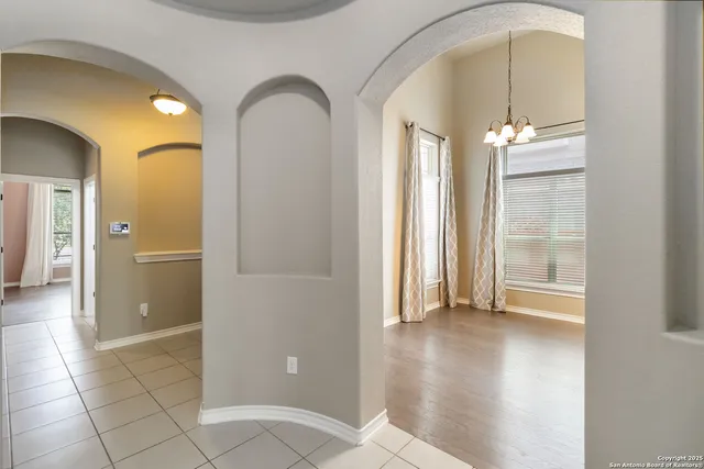 a view of a bathroom with a shower and a mirror