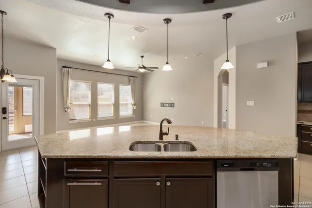 a kitchen with a sink and chandelier