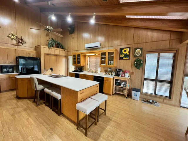 a dining room with furniture water view and wooden floor