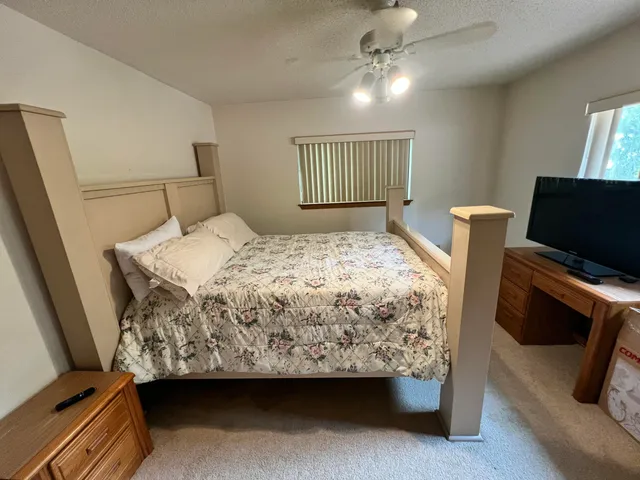 a view of a chairs and table in patio with a barbeque