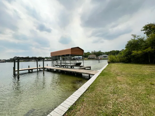 a view of a lake with houses in the back