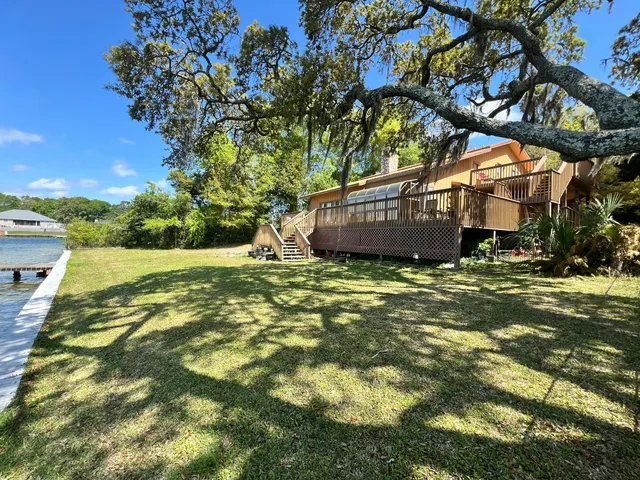a view of a patio with a table and chairs under an umbrella