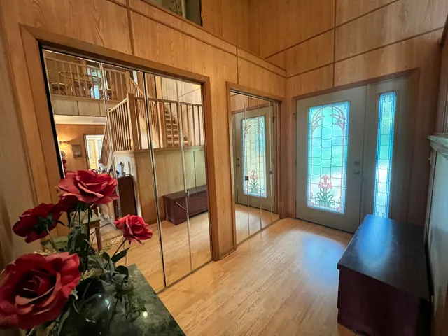 a view of a hallway with workspace and living room