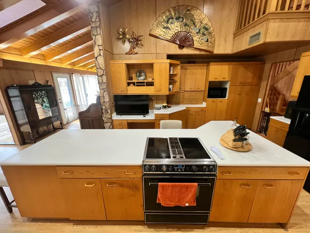 a view of a kitchen with a stove and a microwave
