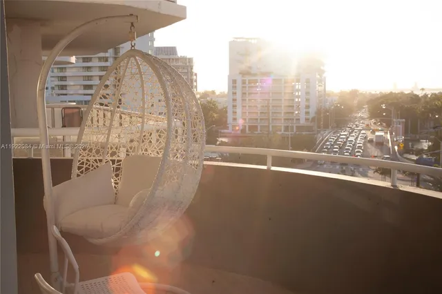 a bedroom with bed and a large window