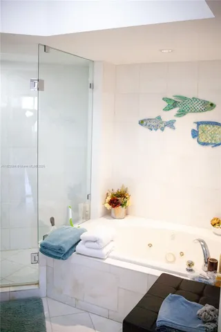 a bathroom with a tub and a shower