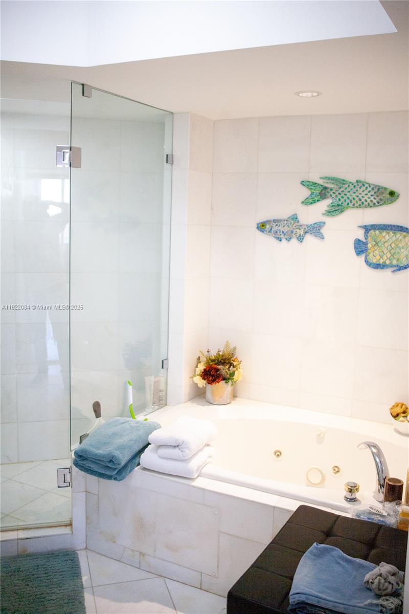 6301 Collins Avenue, Unit 807 Miami Beach, FL 33141 - Photo 22 of 42 a bathroom with a bathtub and shower