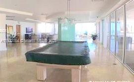 6301 Collins Avenue, Unit 807 Miami Beach, FL 33141 - Photo 40 of 42 a room with lots of windows and glass walls