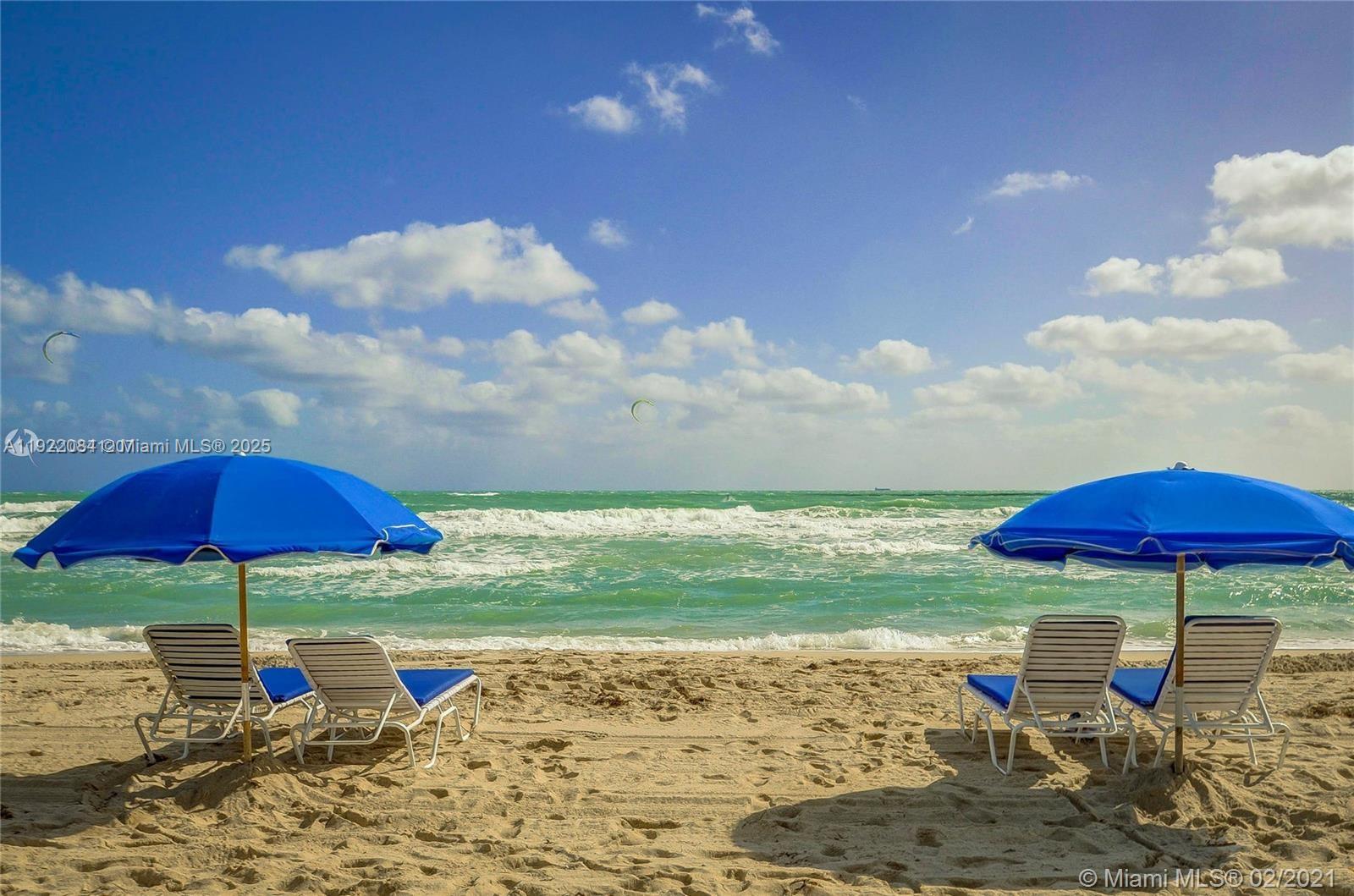 6301 Collins Avenue, Unit 807 Miami Beach, FL 33141 - Photo 4 of 42 a view of a table and chairs under an umbrella