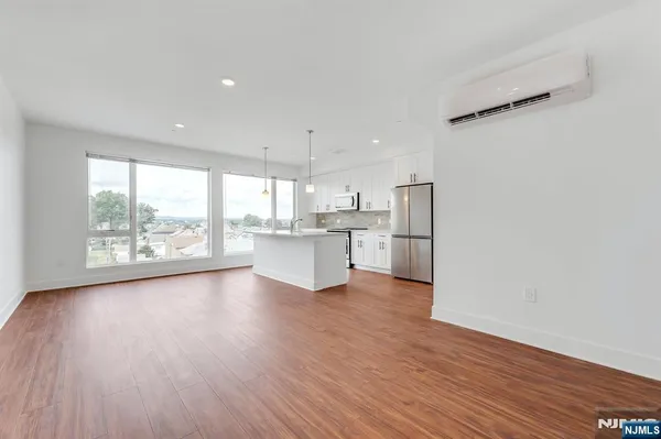 a view of kitchen with wooden floor and electronic appliances