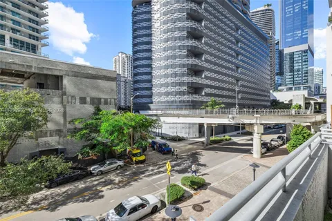 a view of a balcony with a couch and wooden floor