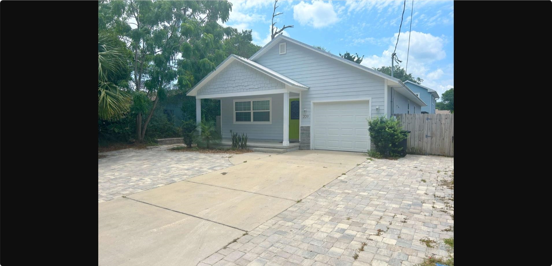 209 7th Street St. Augustine, FL 32080 - Photo 1 of 28 a view of backyard with potted plants and a large tree