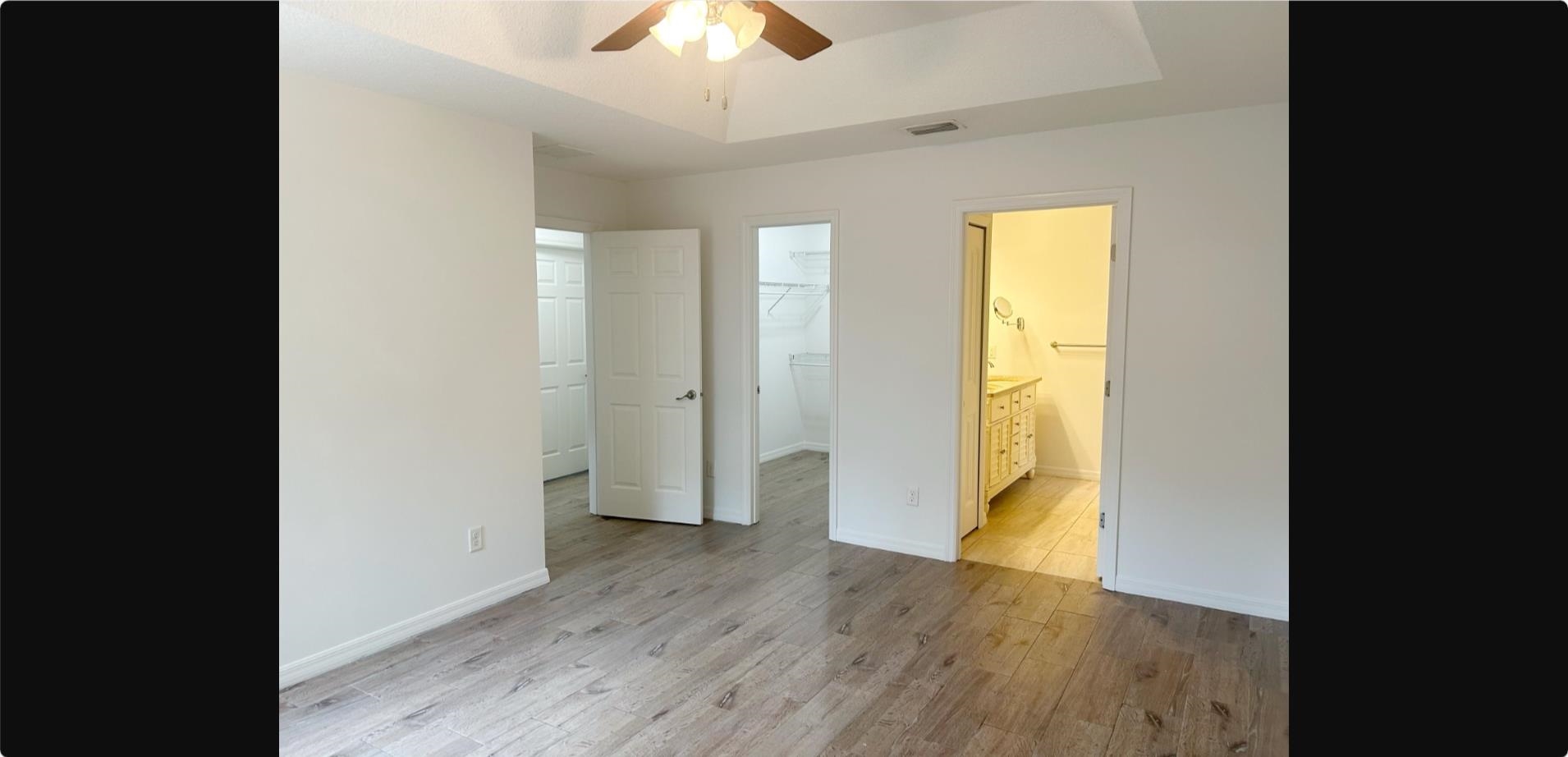 209 7th Street St. Augustine, FL 32080 - Photo 11 of 28 wooden floor in an empty room with a window