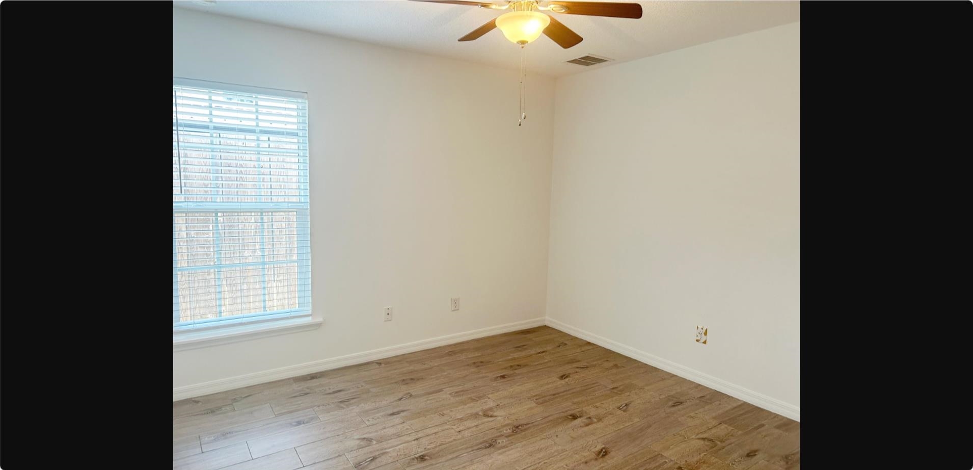 209 7th Street St. Augustine, FL 32080 - Photo 12 of 28 en empty room with wooden floor and window