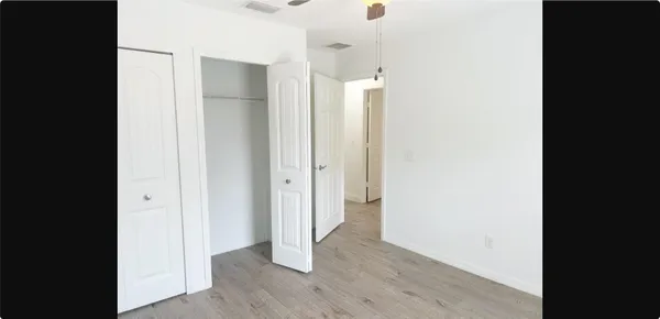 a view of hallway with wooden floor