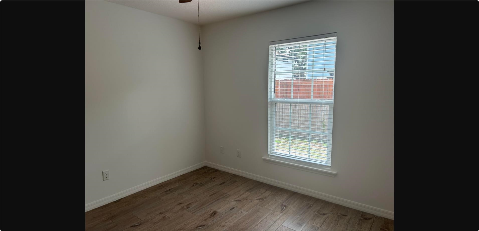 209 7th Street St. Augustine, FL 32080 - Photo 15 of 28 a view of an empty room with wooden floor and a window