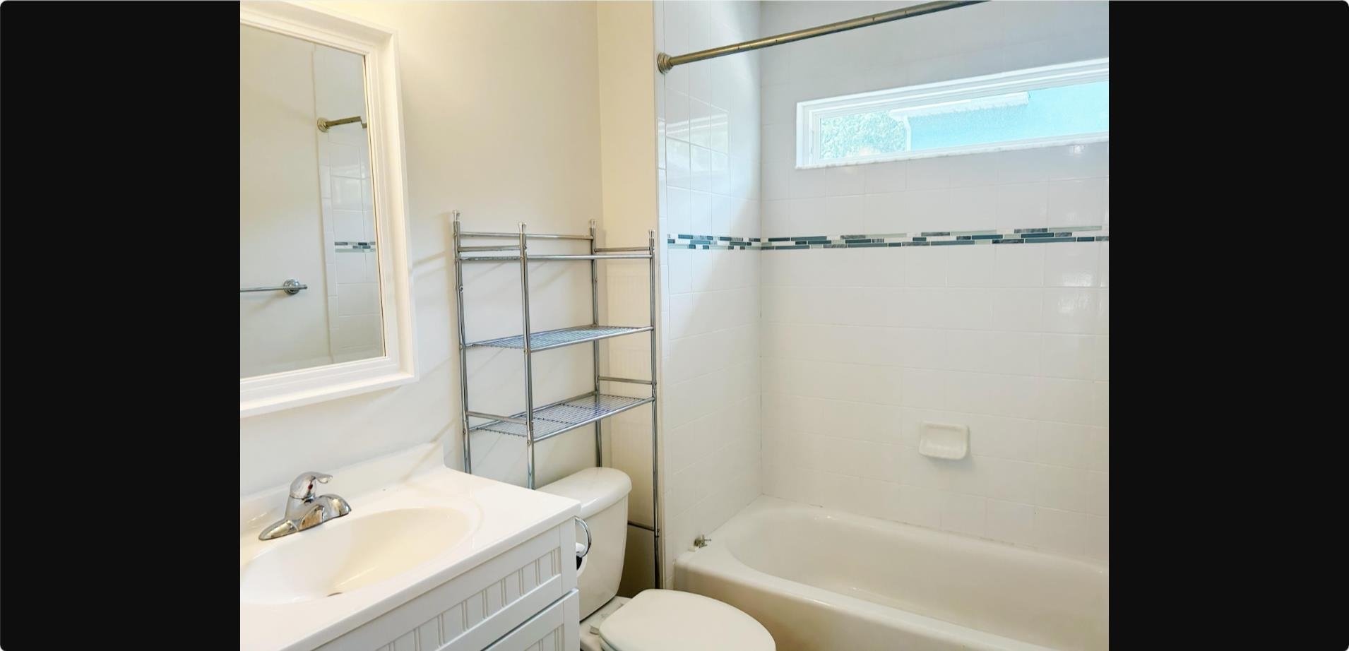 209 7th Street St. Augustine, FL 32080 - Photo 17 of 28 a bathroom with a sink toilet and shower