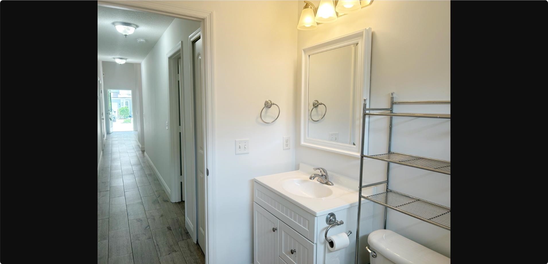 209 7th Street St. Augustine, FL 32080 - Photo 18 of 28 a bathroom with a sink and mirror