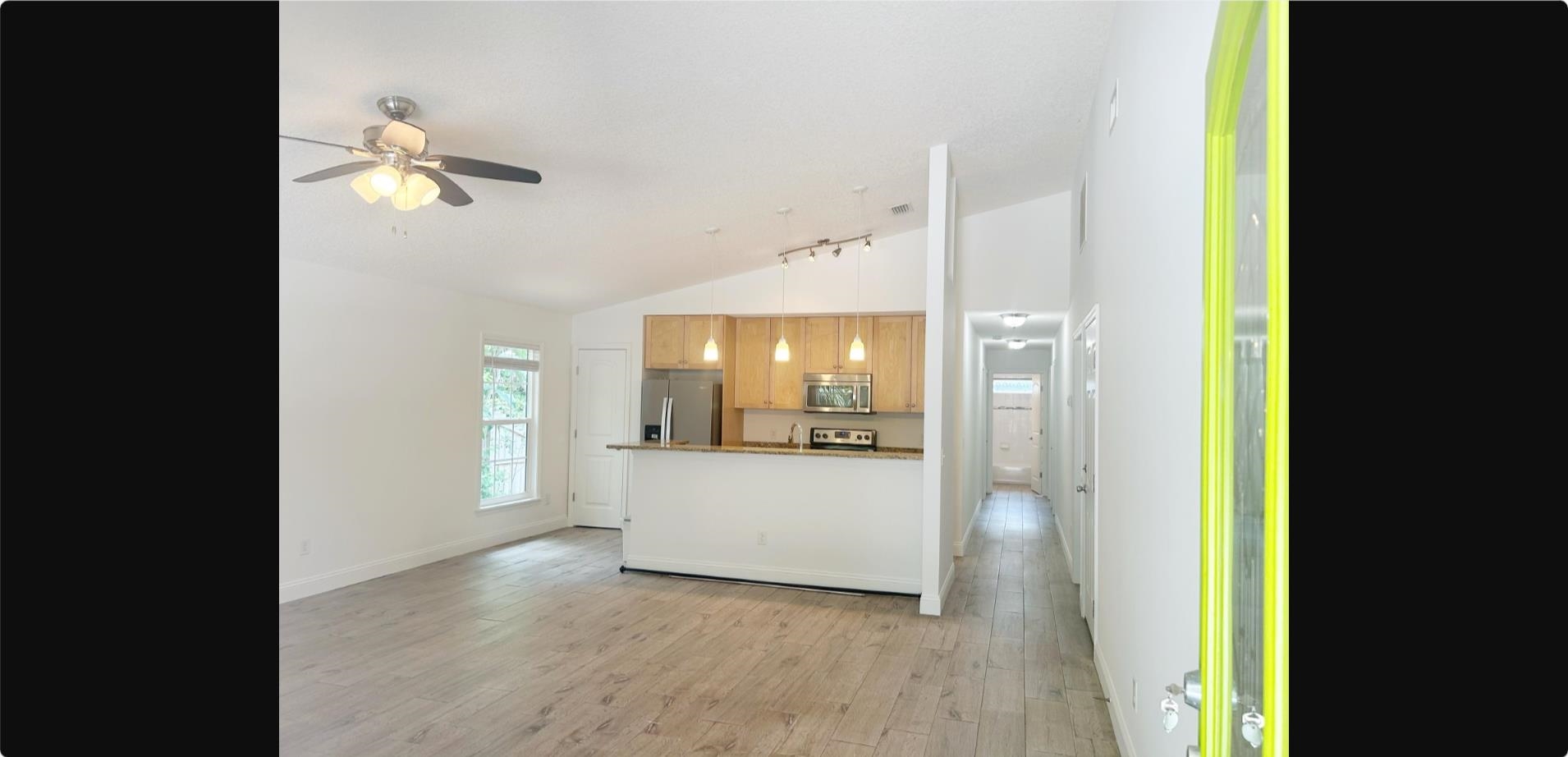 209 7th Street St. Augustine, FL 32080 - Photo 2 of 28 a view of a hallway with wooden floor and a bathroom