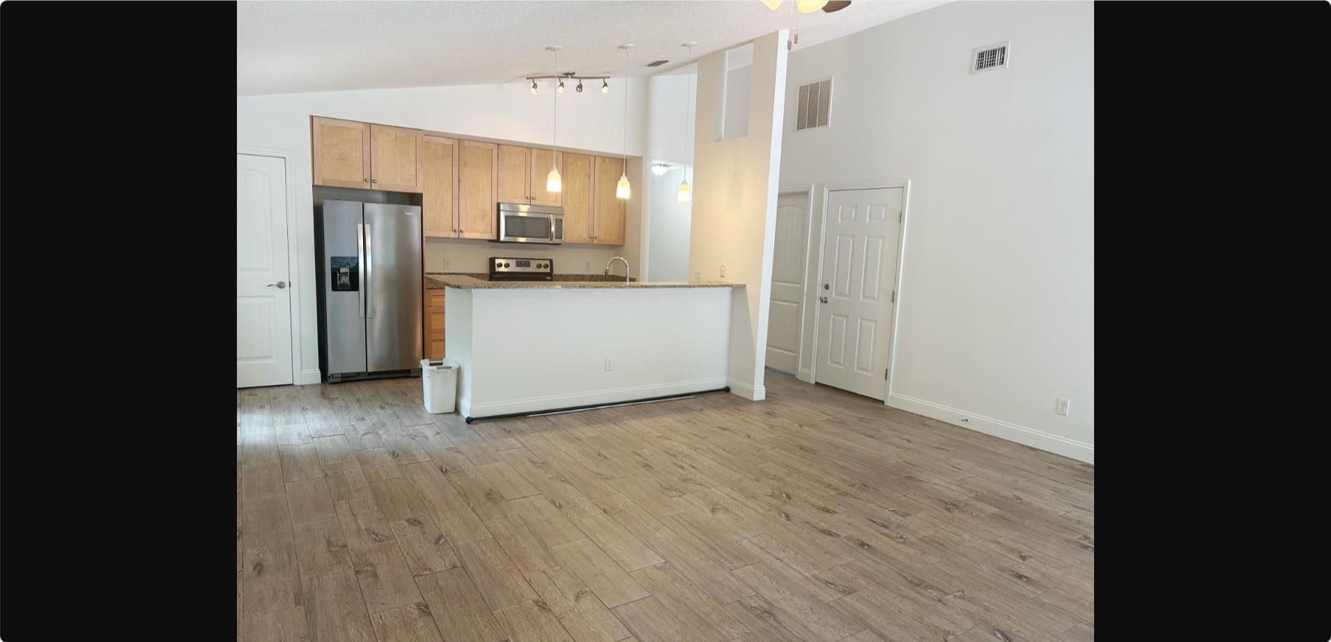 209 7th Street St. Augustine, FL 32080 - Photo 3 of 28 a view of a kitchen with a refrigerator and a sink