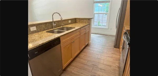 a kitchen with sink a faucet and stove